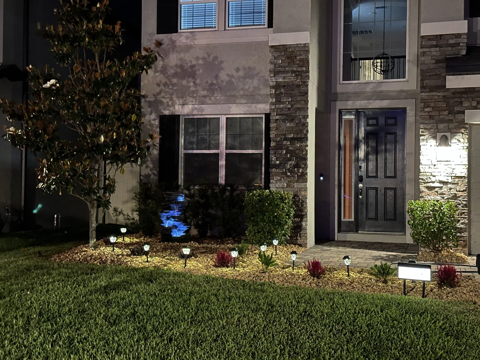 Landscape bed after decorative rock and lighting installation